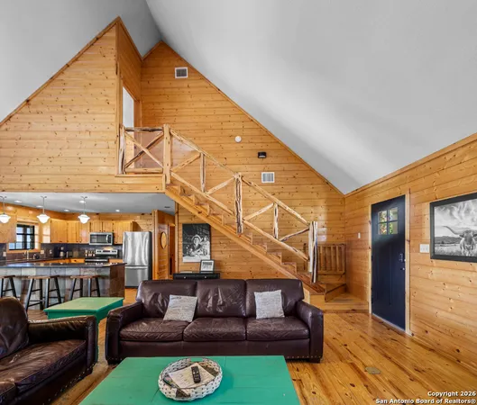 a view of a house with couches chairs and a table