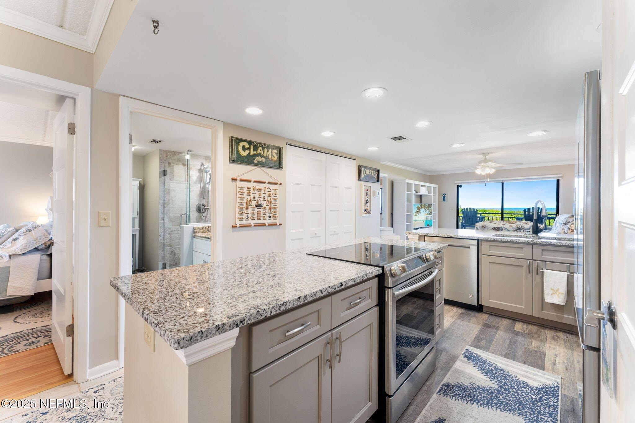 7780 A1A South St. Augustine, FL 32080 - Photo 1 of 1 a kitchen with stainless steel appliances granite countertop a sink and cabinets