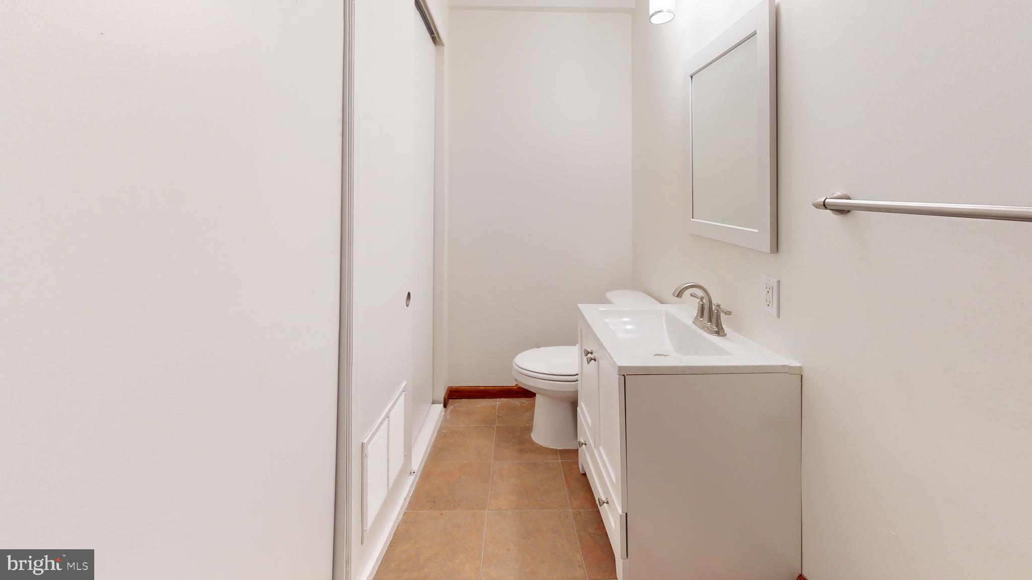 1008 23rd Street Northwest Washington, DC 20037 - Photo 13 of 18 a bathroom with a sink toilet and a mirror