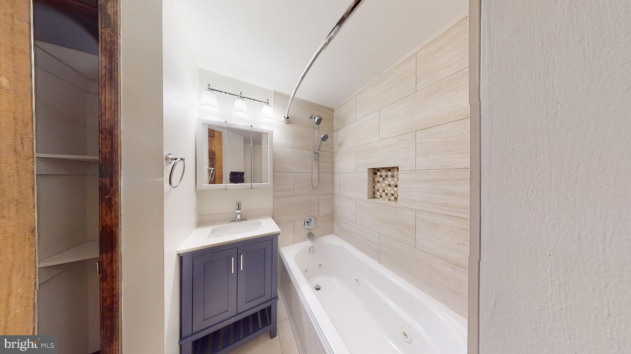 1008 23rd Street Northwest Washington, DC 20037 - Photo 16 of 18 a bathroom with a tub sink and mirror