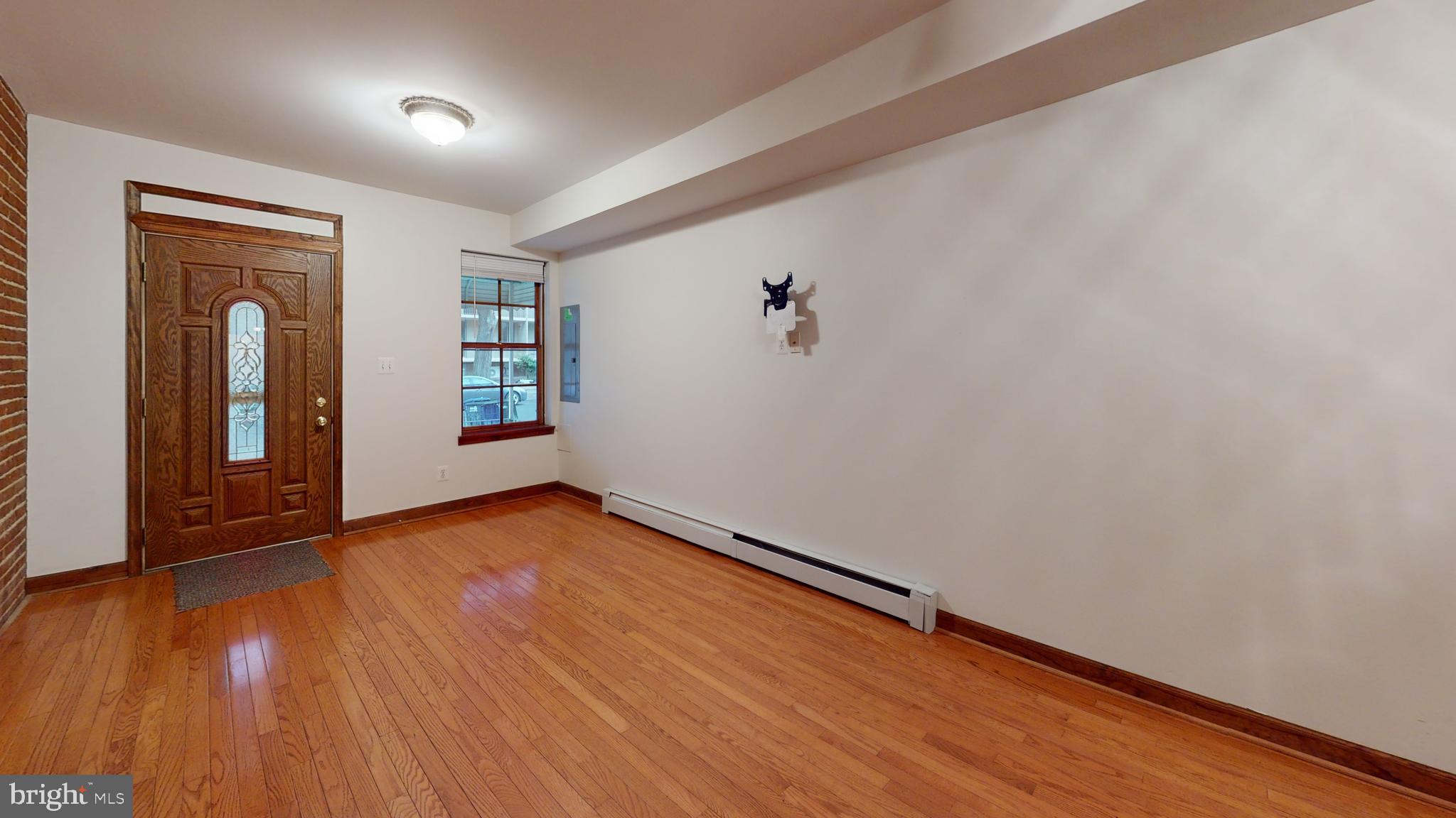 1008 23rd Street Northwest Washington, DC 20037 - Photo 4 of 18 an empty room with wooden floor and windows
