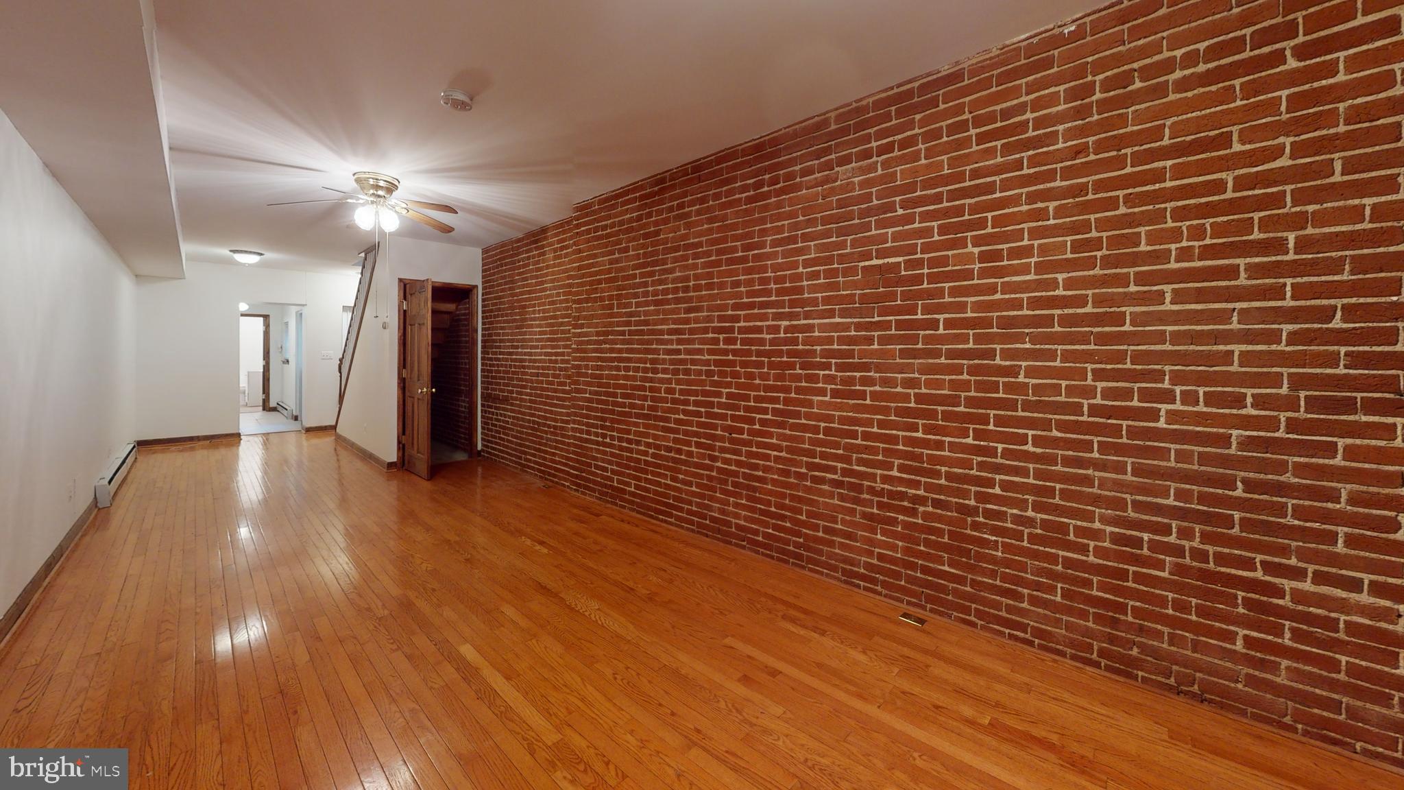 1008 23rd Street Northwest Washington, DC 20037 - Photo 5 of 18 a view of an empty room with wooden floor