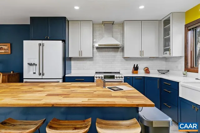 a kitchen with a refrigerator and a stove