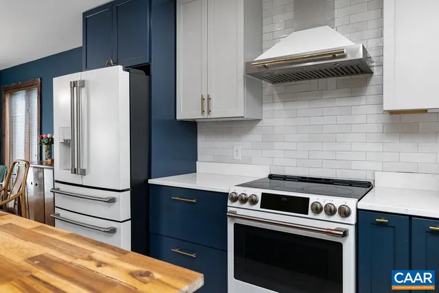 a dining hall with stainless steel appliances granite countertop a kitchen island a stove and a sink