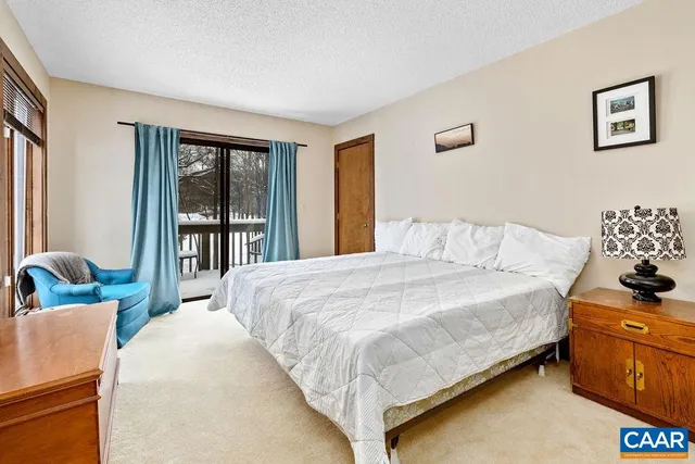 a view of a swimming pool with a yard and large trees