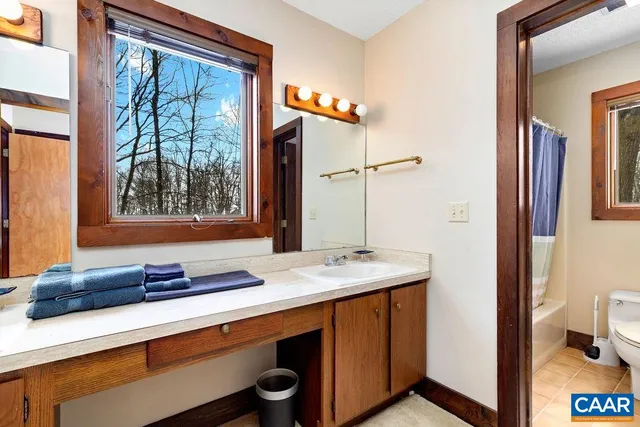 a dining room with furniture a chandelier and wooden floor