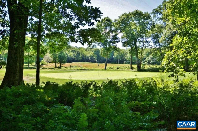 a bedroom with a large bed and a flat tv screen