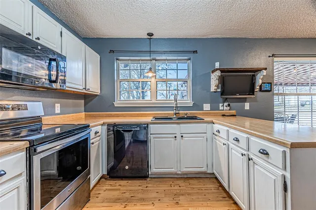 a kitchen with stainless steel appliances granite countertop a sink and a stove top oven