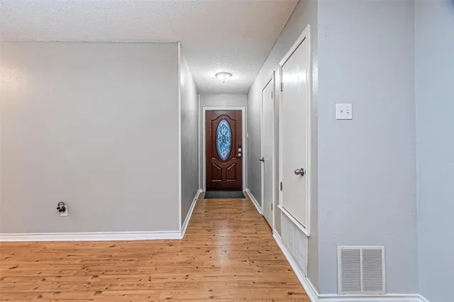 a view of a hallway with wooden floor