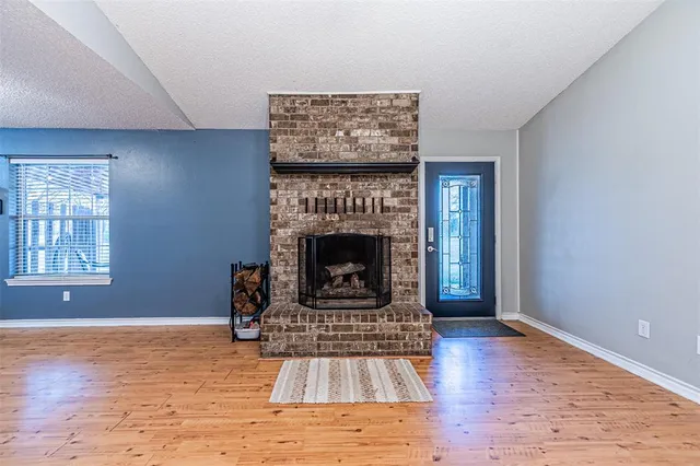 a living room with a fireplace and a fireplace