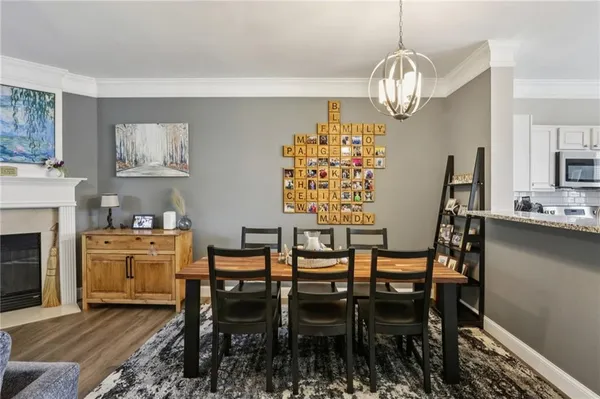 a view of a dining room with furniture and chandelier