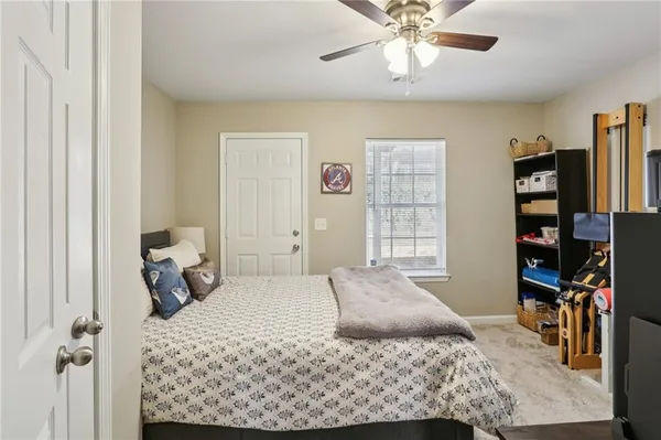 a bedroom with a bed dresser and a window