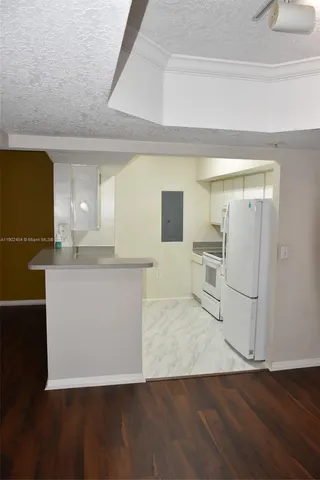 a view of a kitchen cabinets and wooden floor