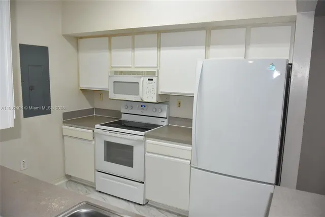 a kitchen with a stove and a refrigerator