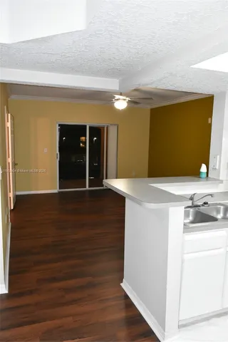 a view of kitchen with cabinets and wooden floor