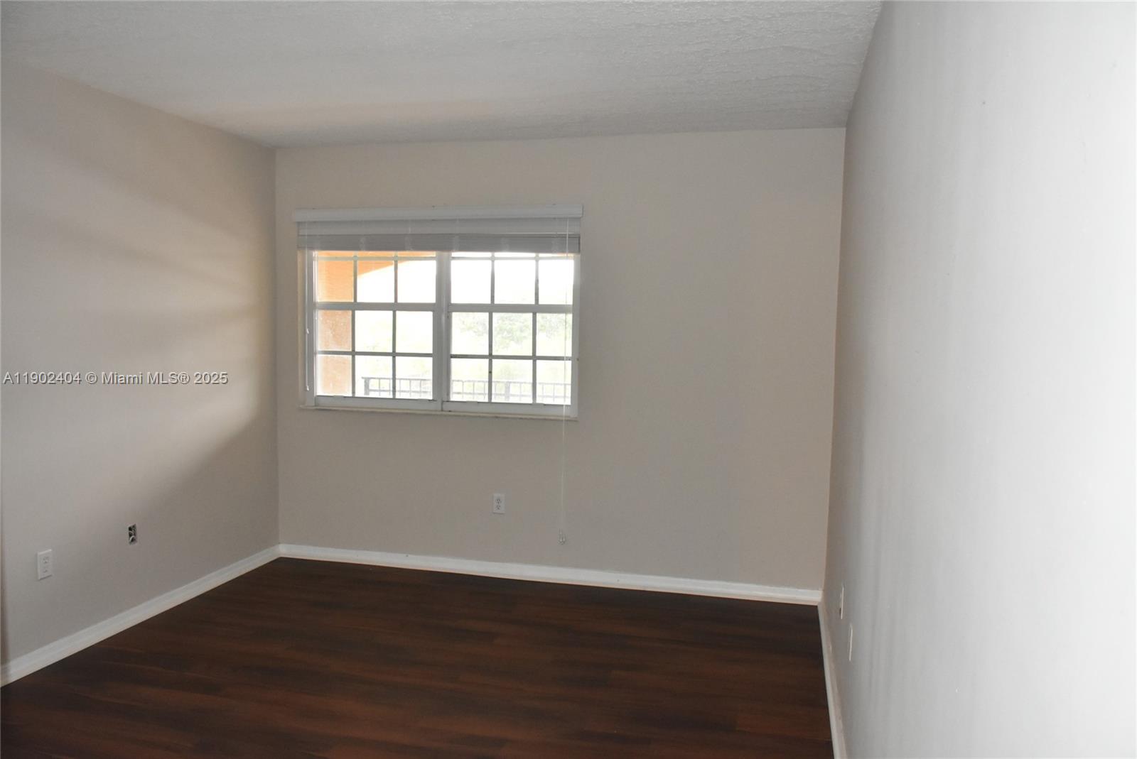 11701 Southwest 2nd Street, Unit 5305 Pembroke Pines, FL 33025 - Photo 9 of 27 an empty room with wooden floor and windows