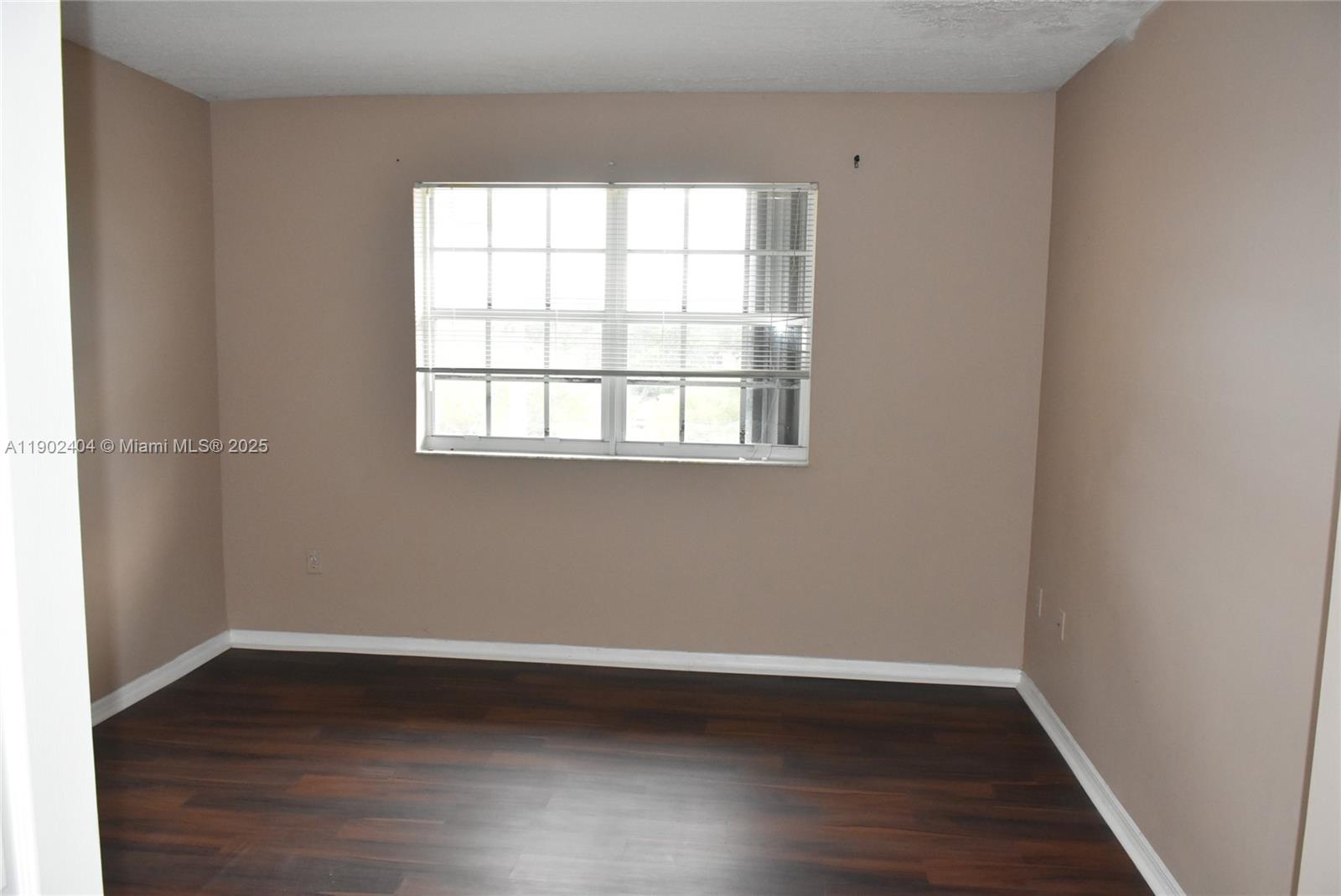 11701 Southwest 2nd Street, Unit 5305 Pembroke Pines, FL 33025 - Photo 10 of 27 an empty room with wooden floor and windows