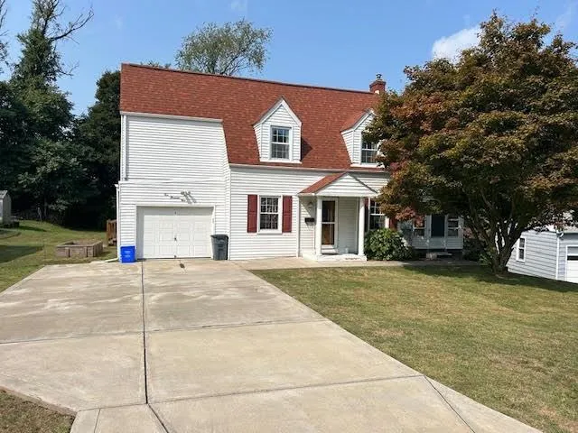 a view of a white house with a large space