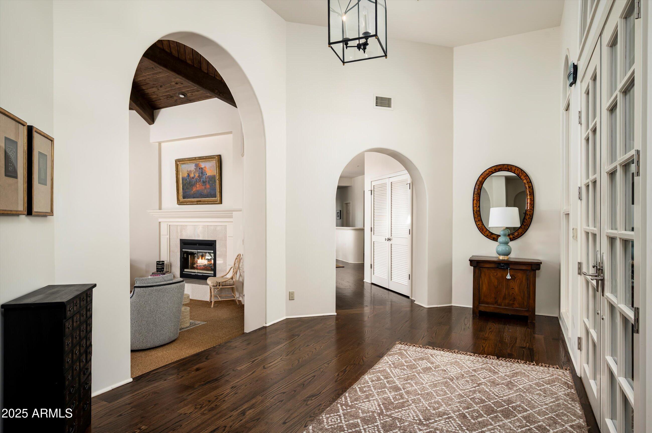 10040 East Happy Valley Road, Unit 274 Scottsdale, AZ 85255 - Photo 11 of 73 a living room with furniture a fireplace and wooden floor