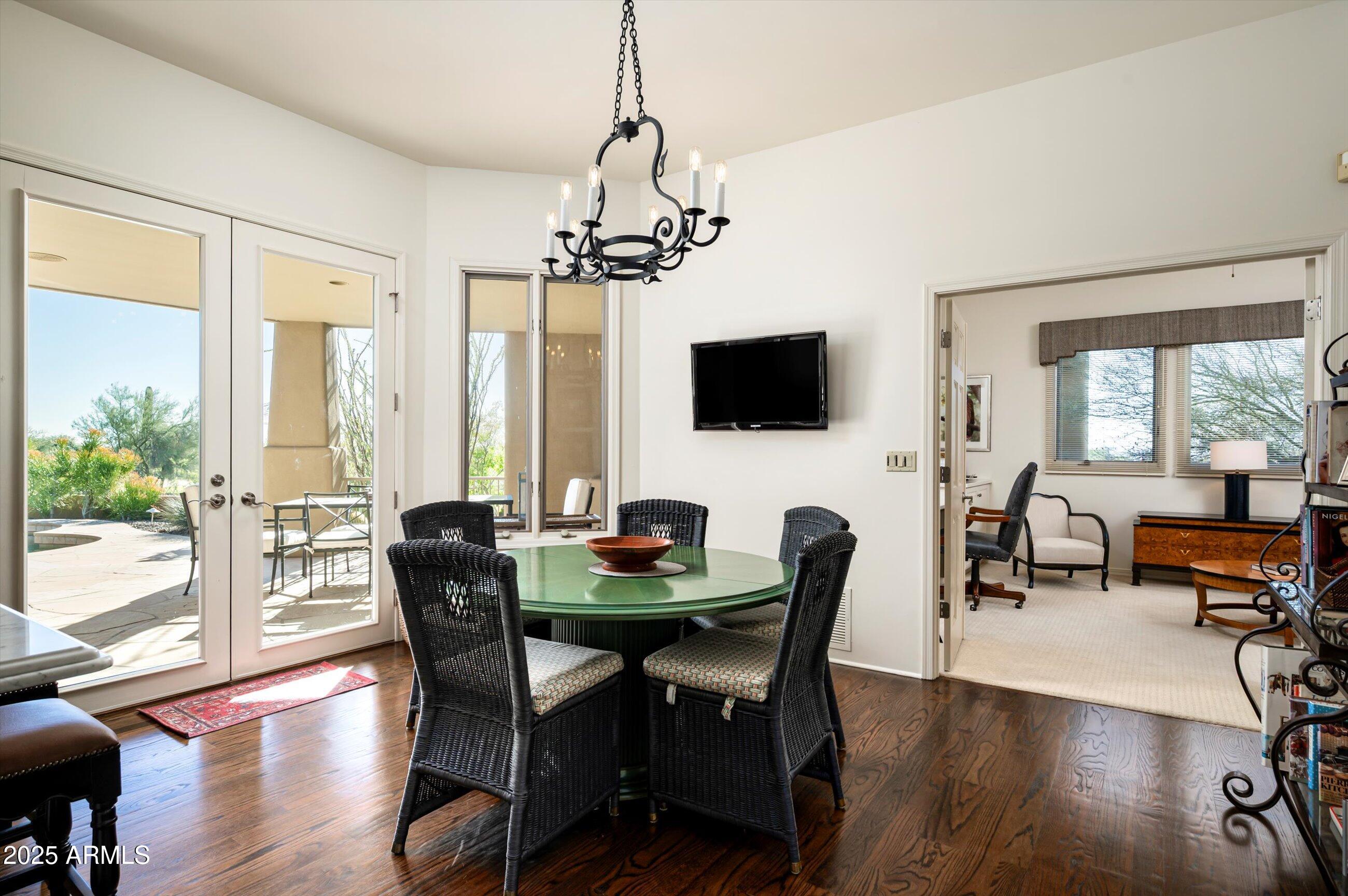 10040 East Happy Valley Road, Unit 274 Scottsdale, AZ 85255 - Photo 22 of 73 a view of a dining room with furniture window and wooden floor
