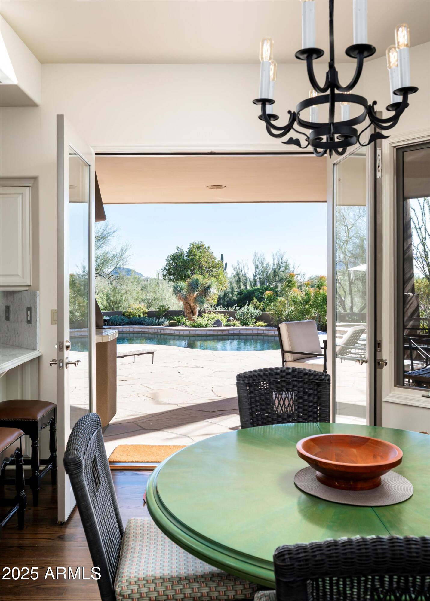 10040 East Happy Valley Road, Unit 274 Scottsdale, AZ 85255 - Photo 23 of 73 a view of a swimming pool with a table and chairs