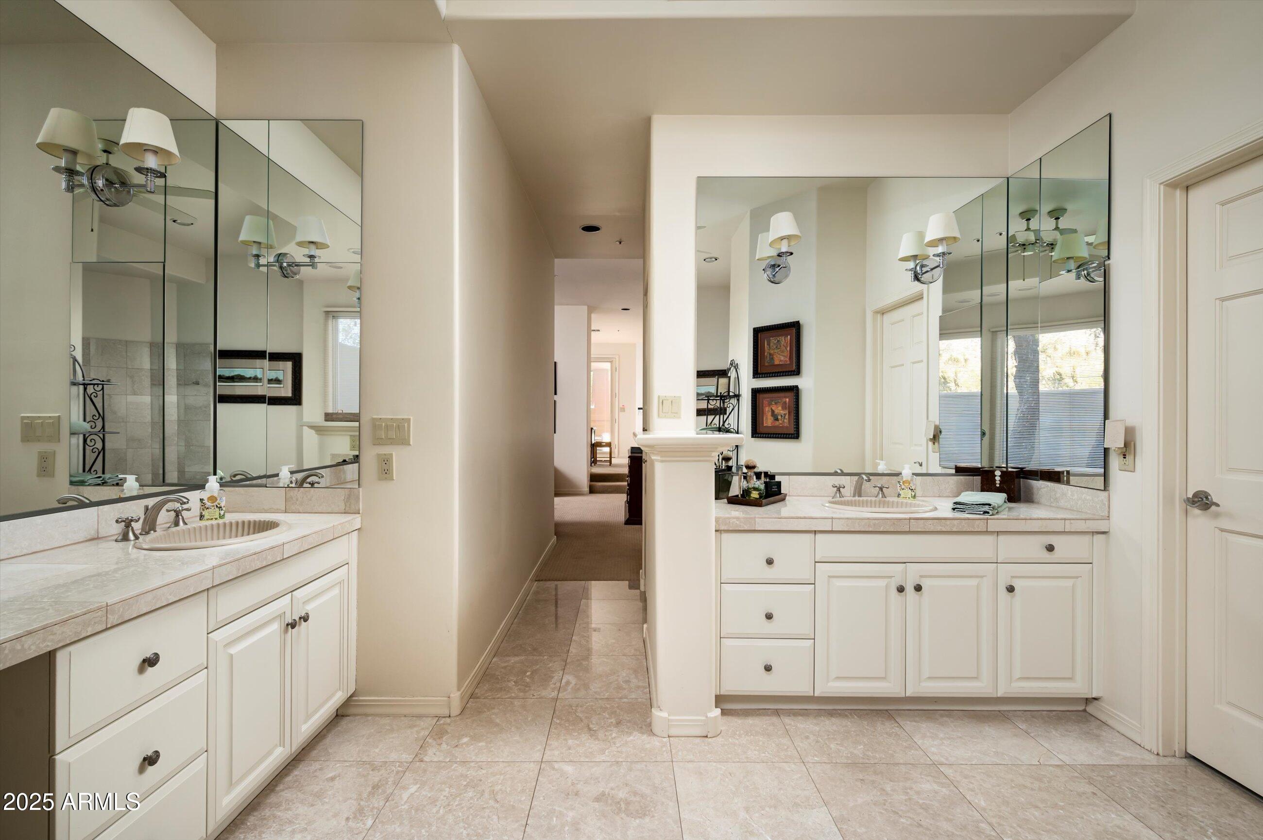 10040 East Happy Valley Road, Unit 274 Scottsdale, AZ 85255 - Photo 31 of 73 a spacious bathroom with a granite countertop sink mirror and a