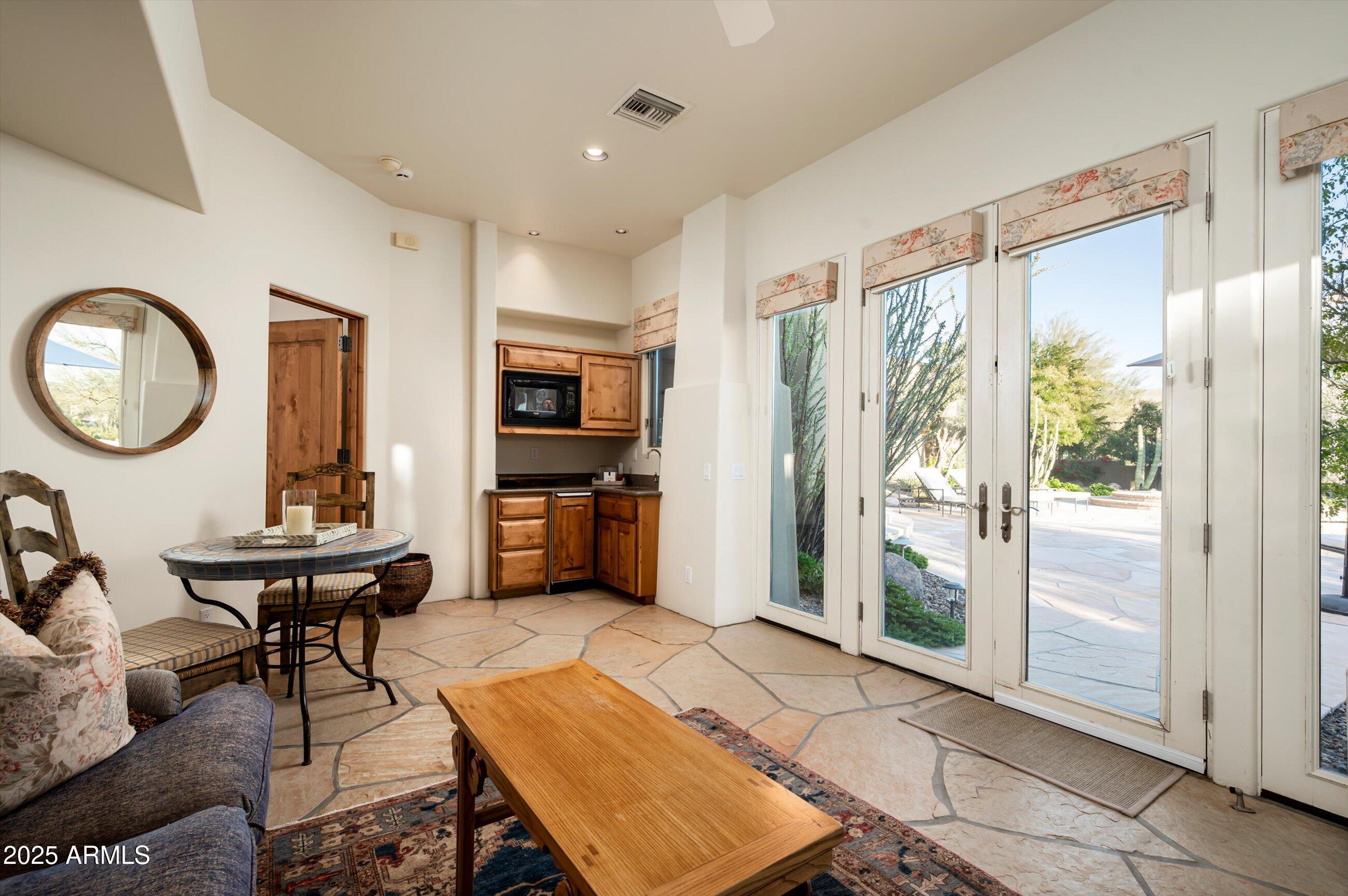 10040 East Happy Valley Road, Unit 274 Scottsdale, AZ 85255 - Photo 39 of 73 a living room with furniture a rug and a large window