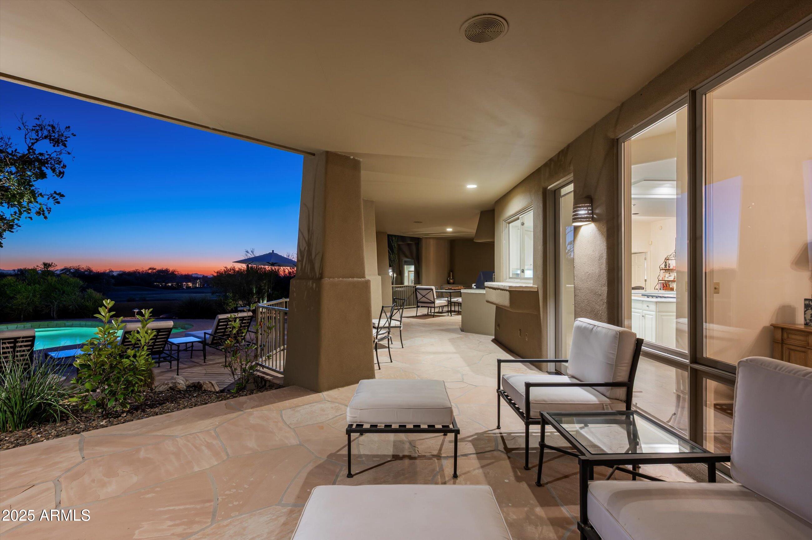 10040 East Happy Valley Road, Unit 274 Scottsdale, AZ 85255 - Photo 51 of 73 a living room with furniture a city view and a large window