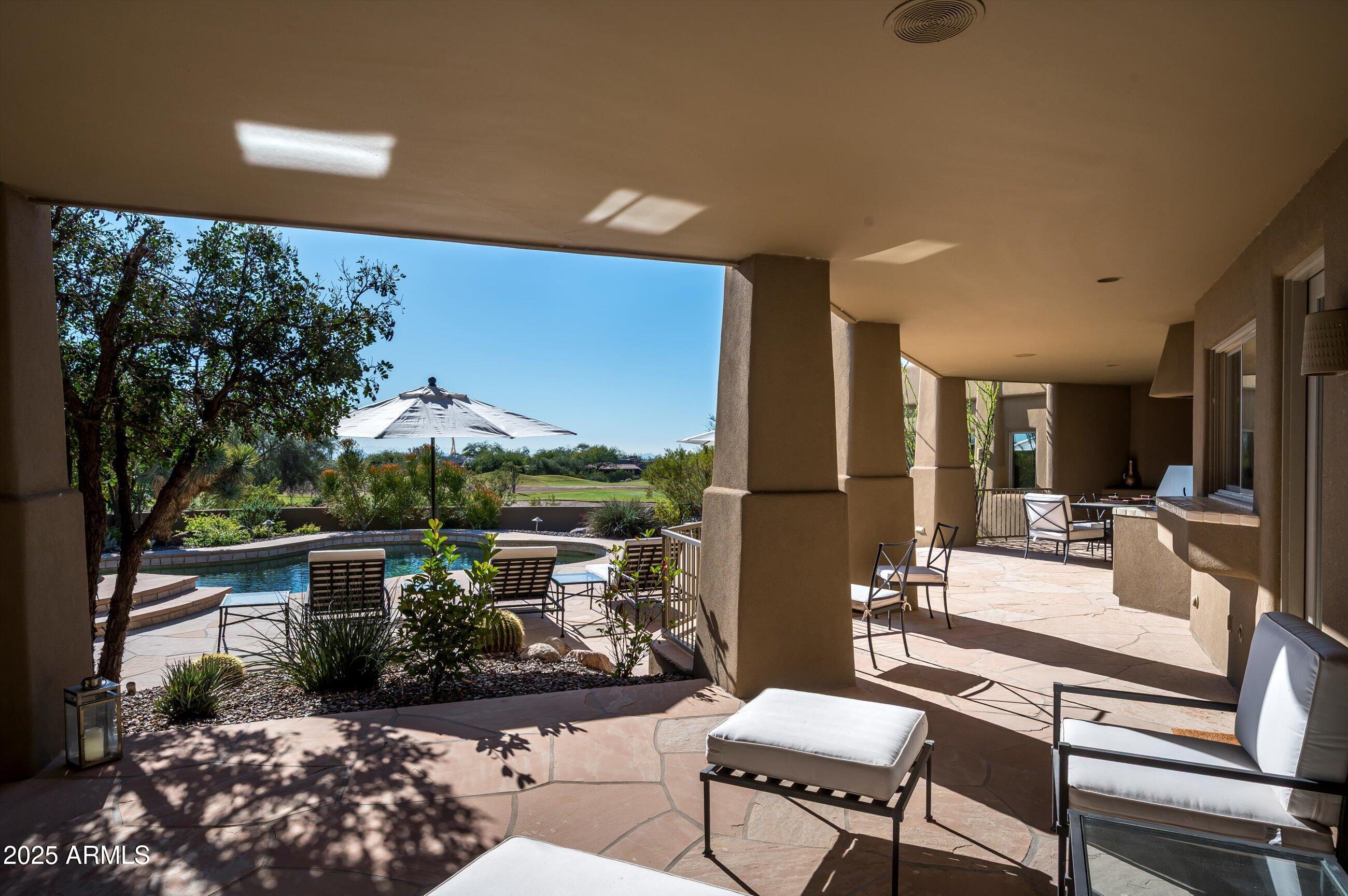 10040 East Happy Valley Road, Unit 274 Scottsdale, AZ 85255 - Photo 52 of 73 a building outdoor space with patio furniture and potted plants