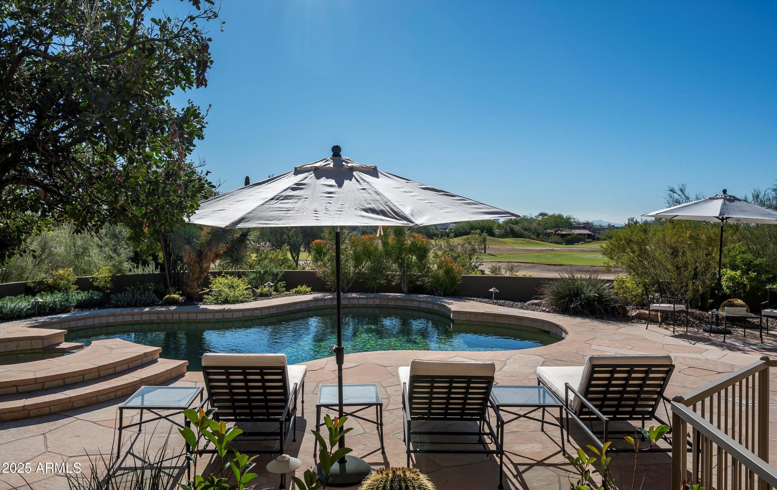 10040 East Happy Valley Road, Unit 274 Scottsdale, AZ 85255 - Photo 7 of 73 an outdoor space with furniture and umbrella