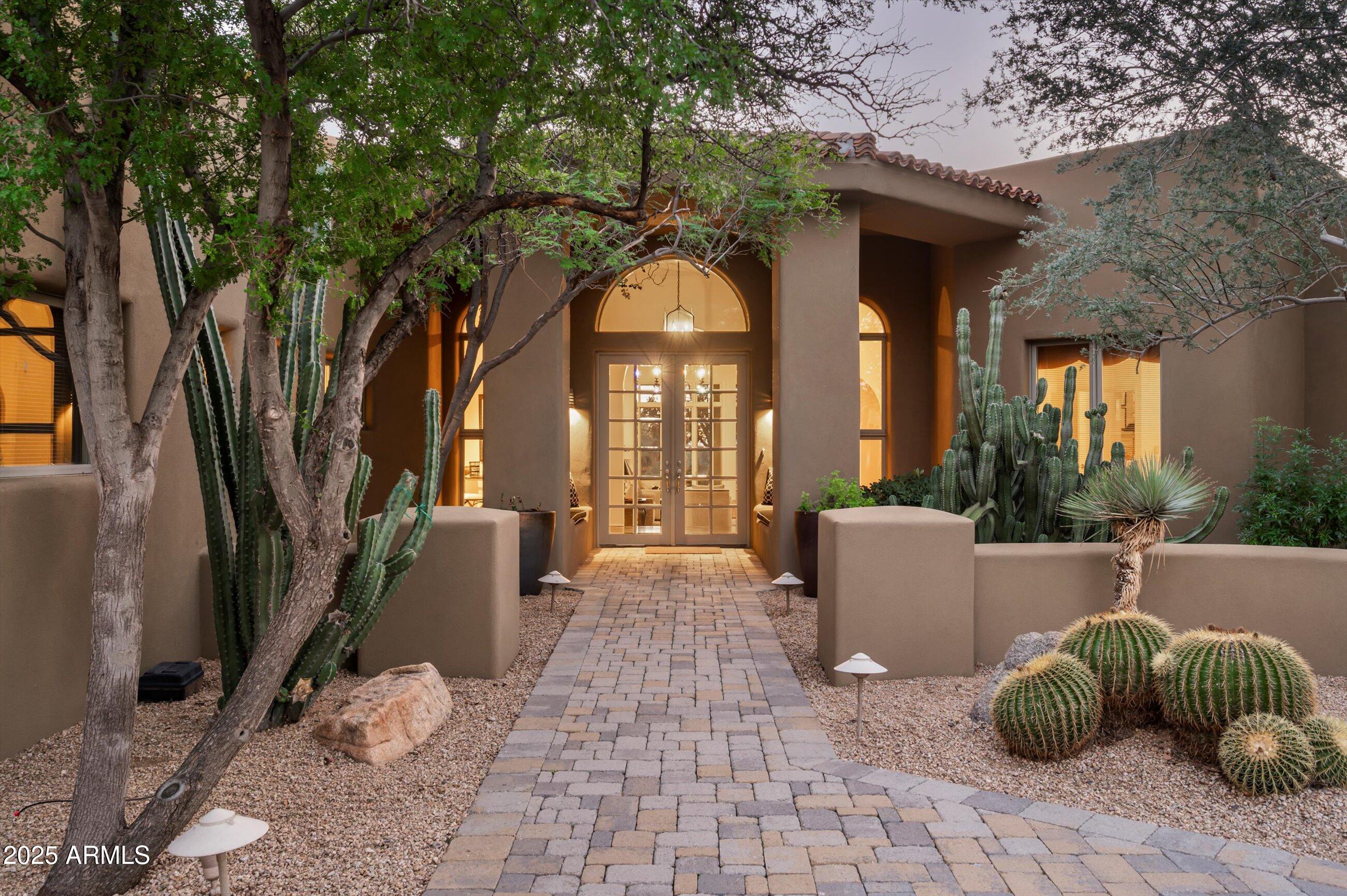 10040 East Happy Valley Road, Unit 274 Scottsdale, AZ 85255 - Photo 10 of 73 a front view of a house with garden