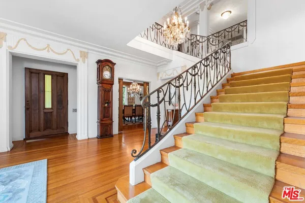 a view of entryway and hall with wooden floor