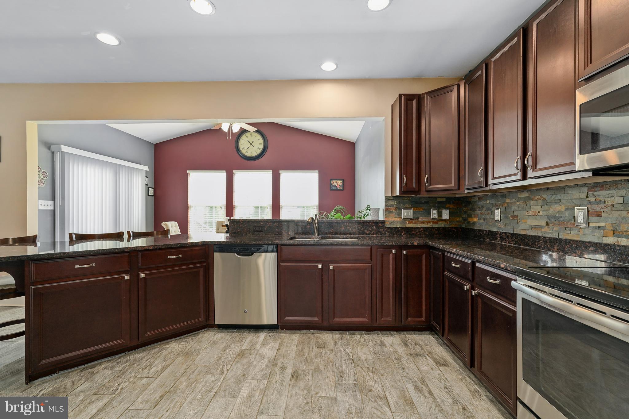 144 Abbigail Crossing Townsend, DE 19734 - Photo 11 of 33 a kitchen with stainless steel appliances granite countertop a sink and a stove
