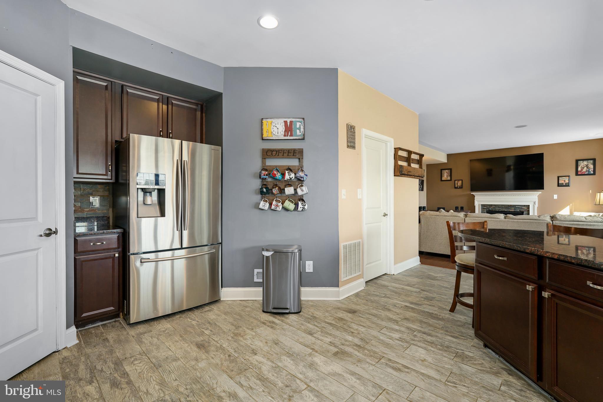 144 Abbigail Crossing Townsend, DE 19734 - Photo 12 of 33 a kitchen with stainless steel appliances granite countertop a refrigerator and a stove top oven