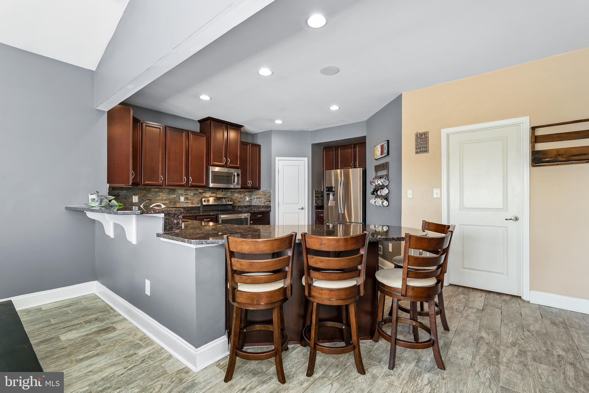 144 Abbigail Crossing Townsend, DE 19734 - Photo 13 of 33 a dining area with stainless steel appliances kitchen island granite countertop a dining table and chairs