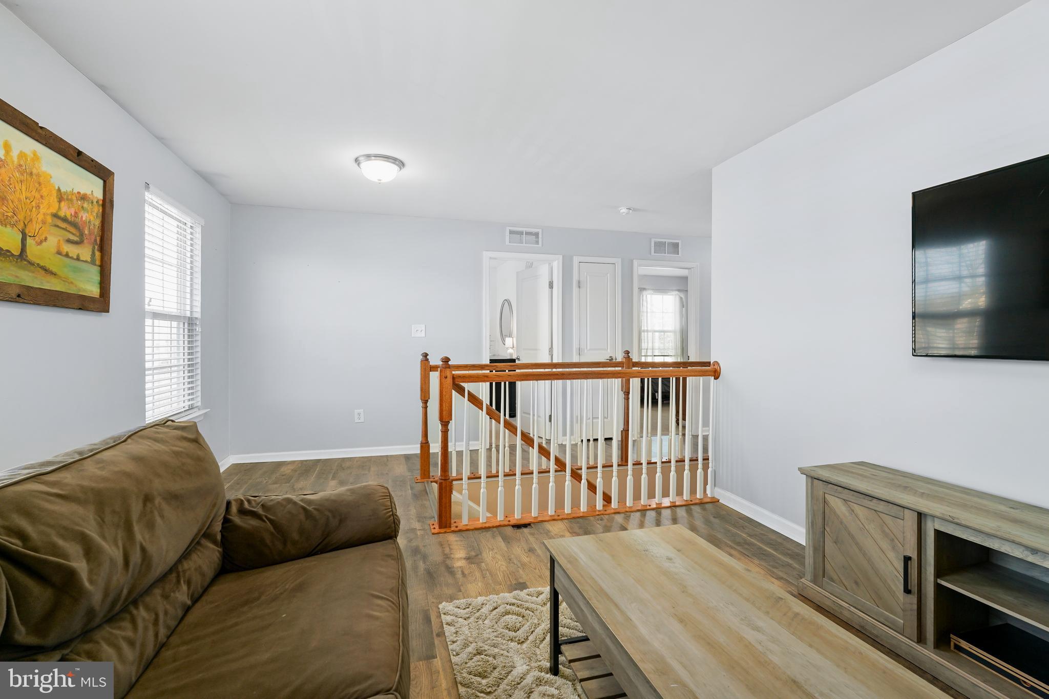 144 Abbigail Crossing Townsend, DE 19734 - Photo 18 of 33 a living room with furniture and a flat screen tv