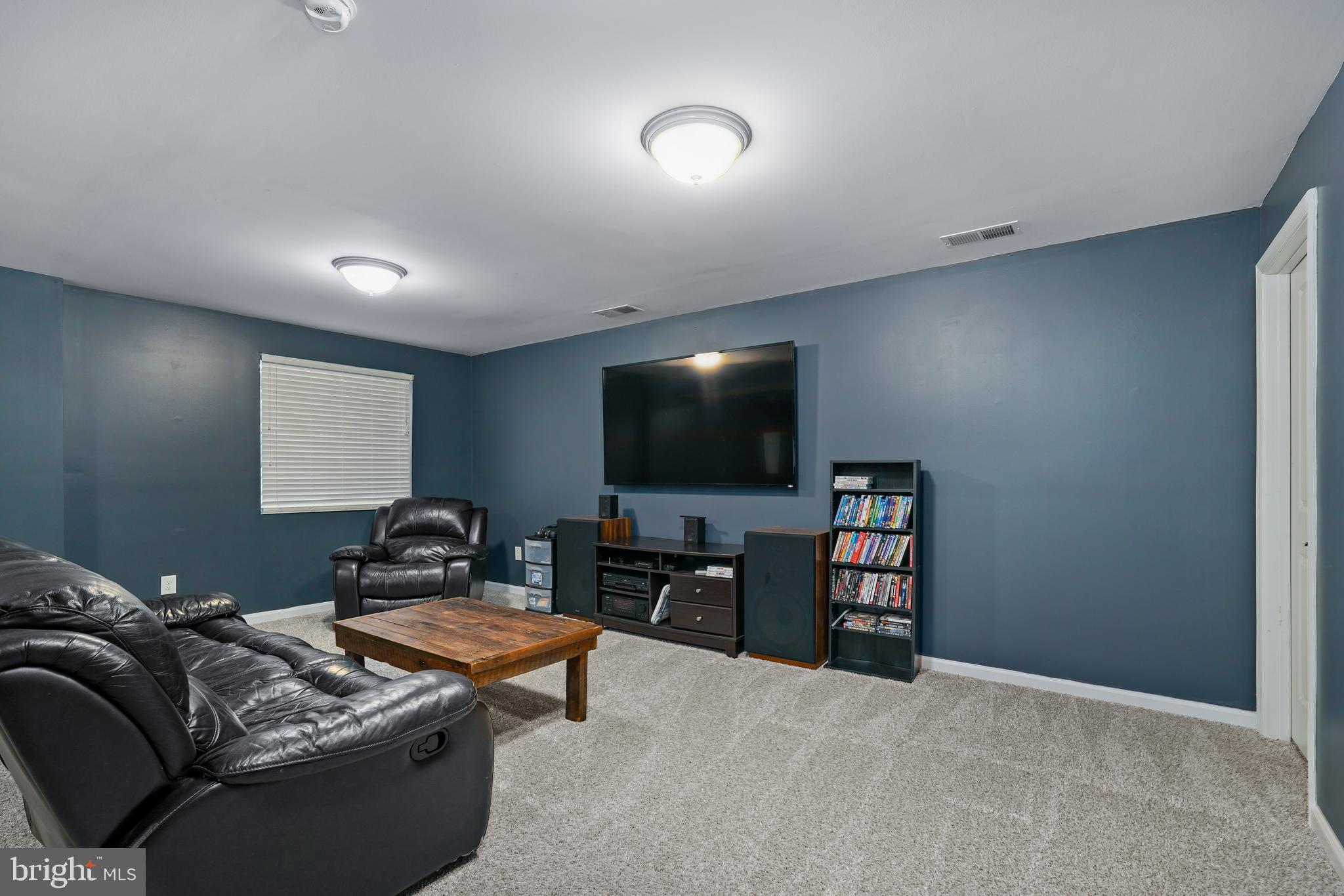 144 Abbigail Crossing Townsend, DE 19734 - Photo 25 of 33 a living room with furniture and a flat screen tv