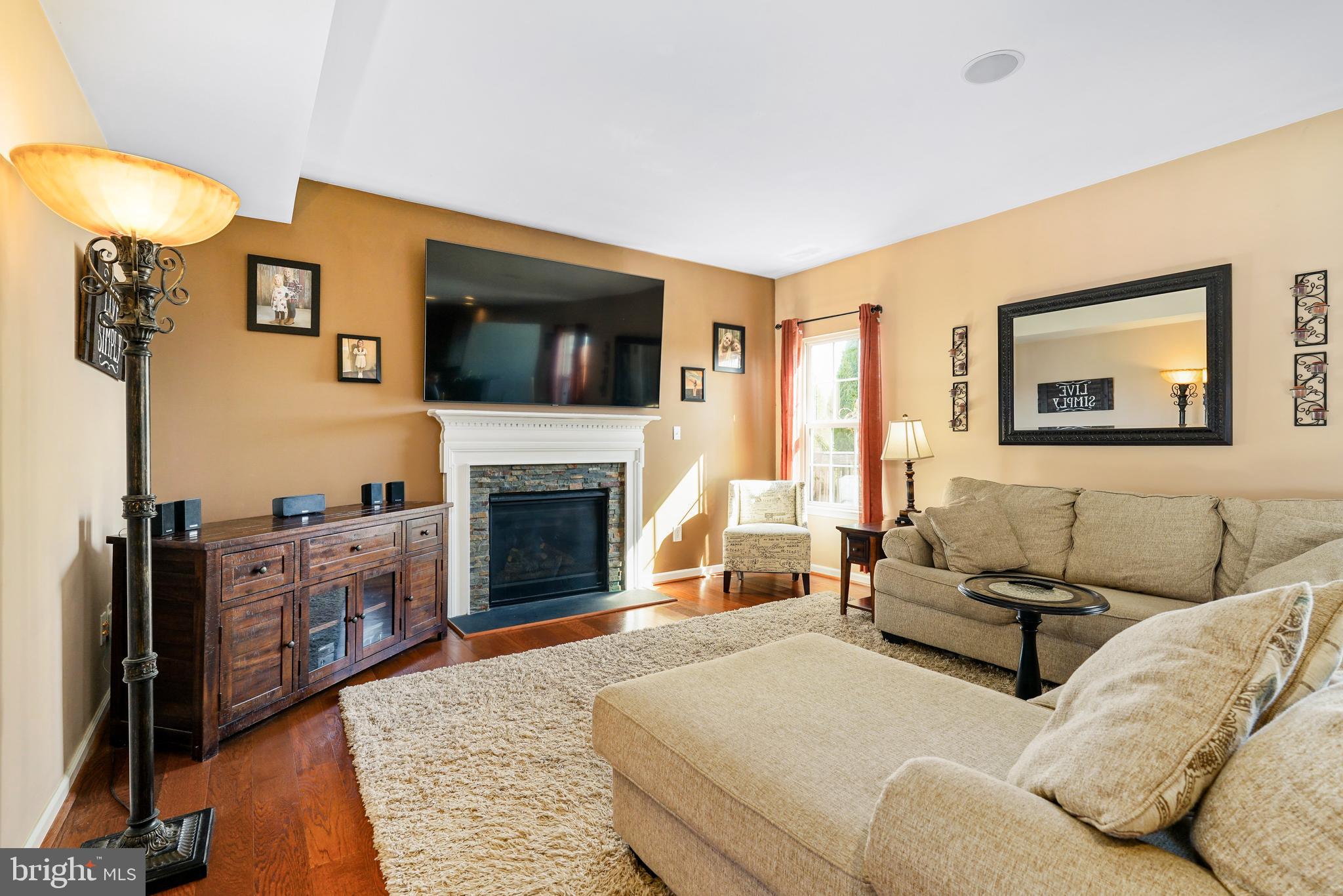 144 Abbigail Crossing Townsend, DE 19734 - Photo 8 of 33 a living room with furniture a flat screen tv and a fireplace
