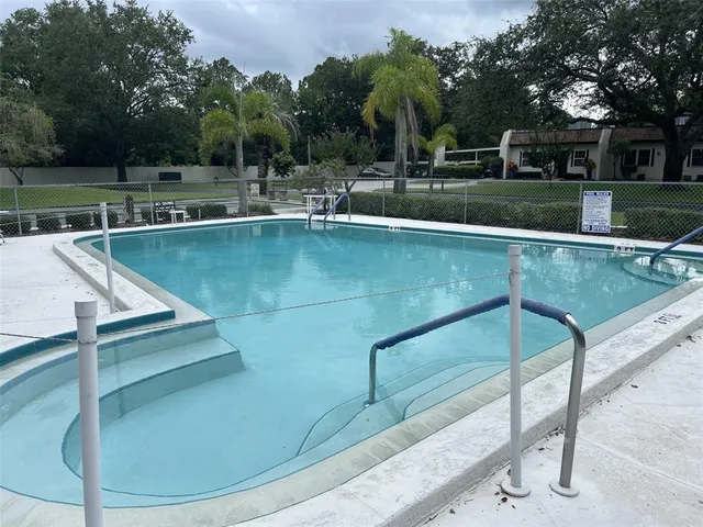 a view of a swimming pool with a patio