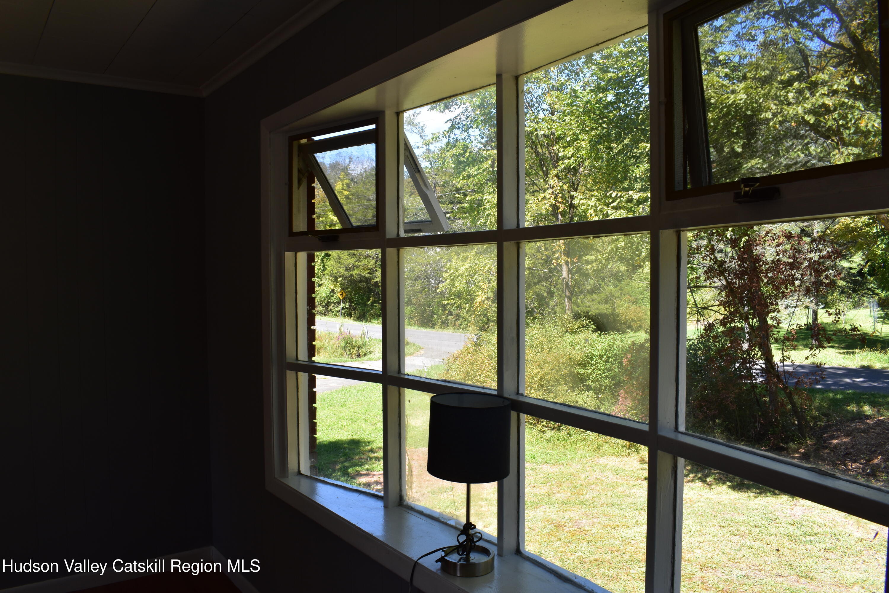 64 Dashville Road New Paltz, NY 12561 - Photo 13 of 45 a view of an empty room with wooden floor and windows