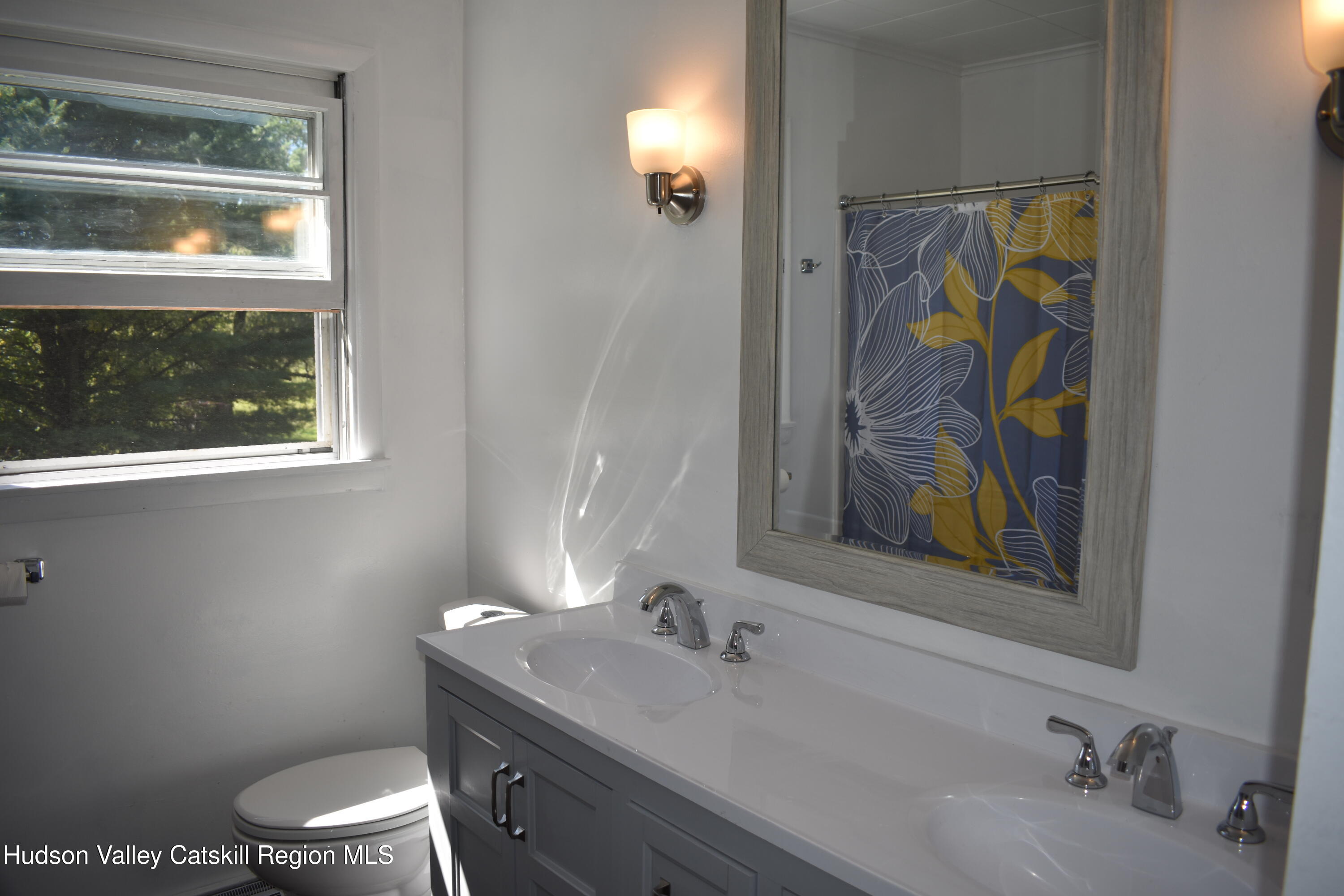 64 Dashville Road New Paltz, NY 12561 - Photo 20 of 45 a bathroom with a toilet sink and mirror