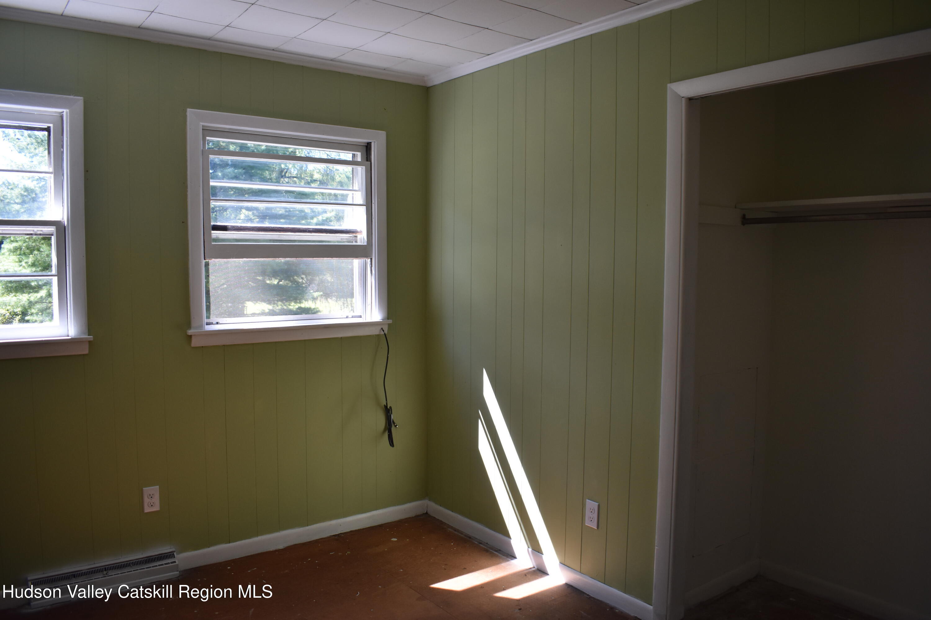 64 Dashville Road New Paltz, NY 12561 - Photo 22 of 45 a view of an empty room with a window and wooden floor