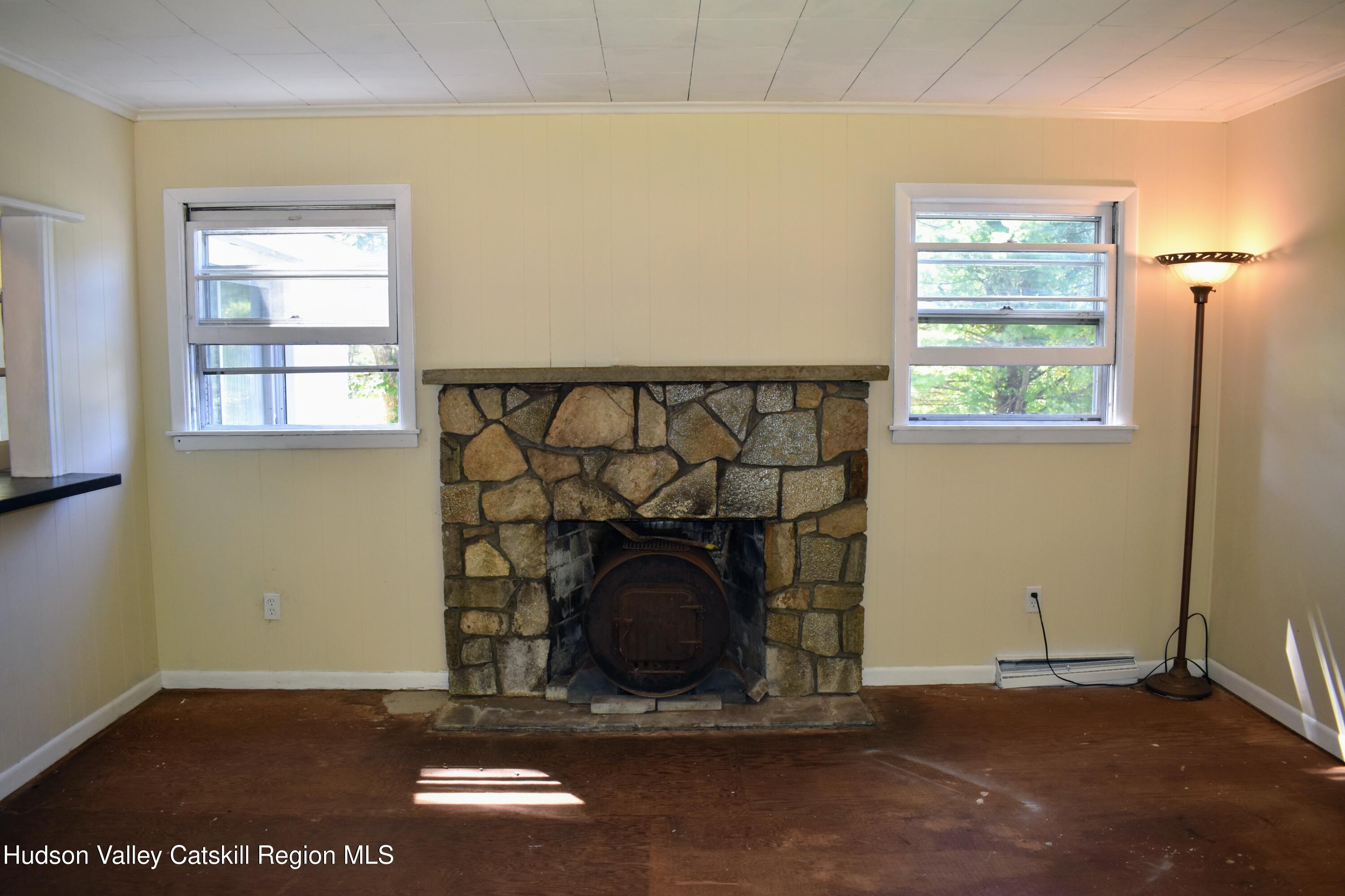 64 Dashville Road New Paltz, NY 12561 - Photo 32 of 45 a living room with a fireplace and a window