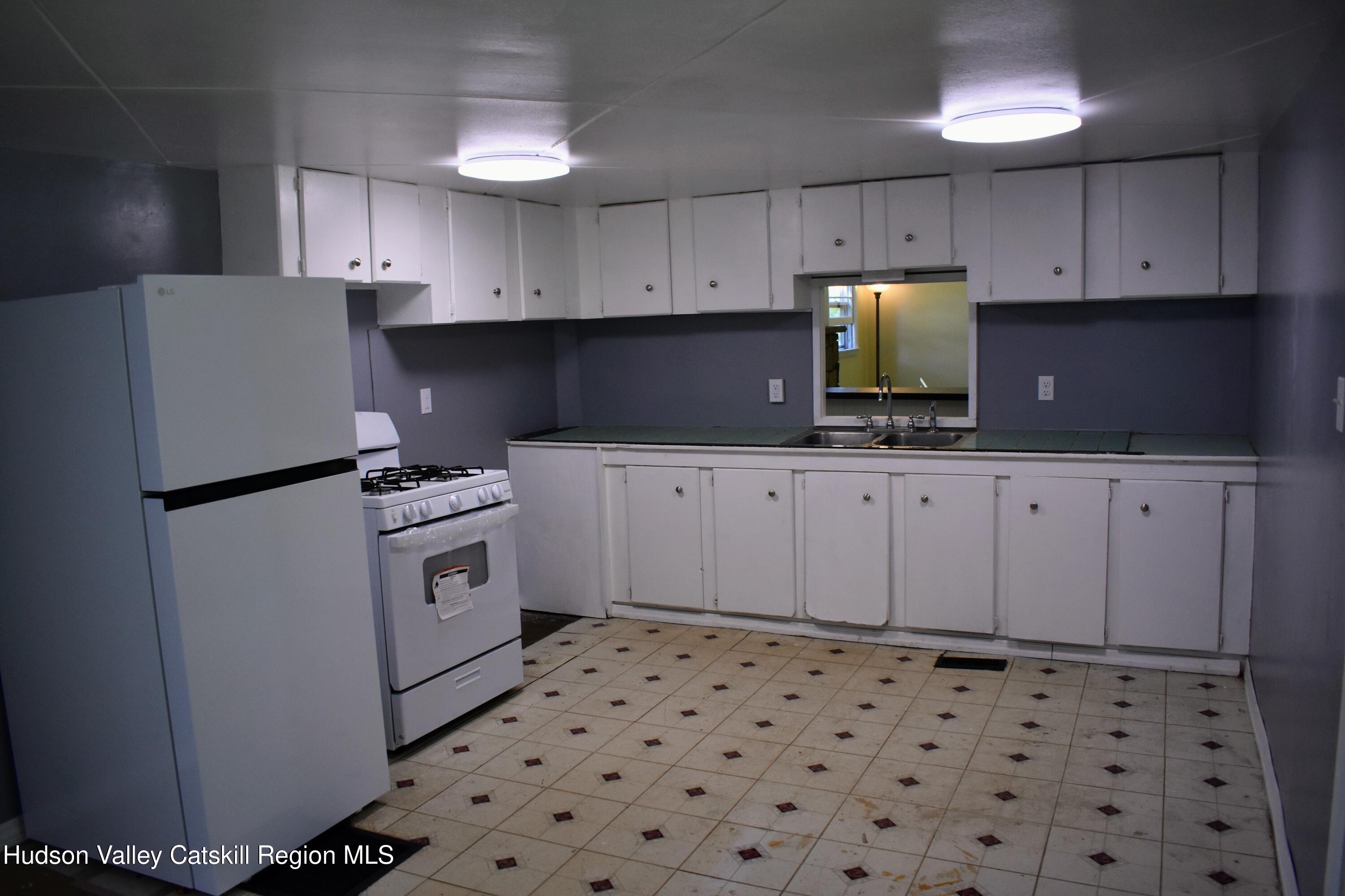 64 Dashville Road New Paltz, NY 12561 - Photo 7 of 45 a kitchen with granite countertop a sink a stove a refrigerator and cabinets