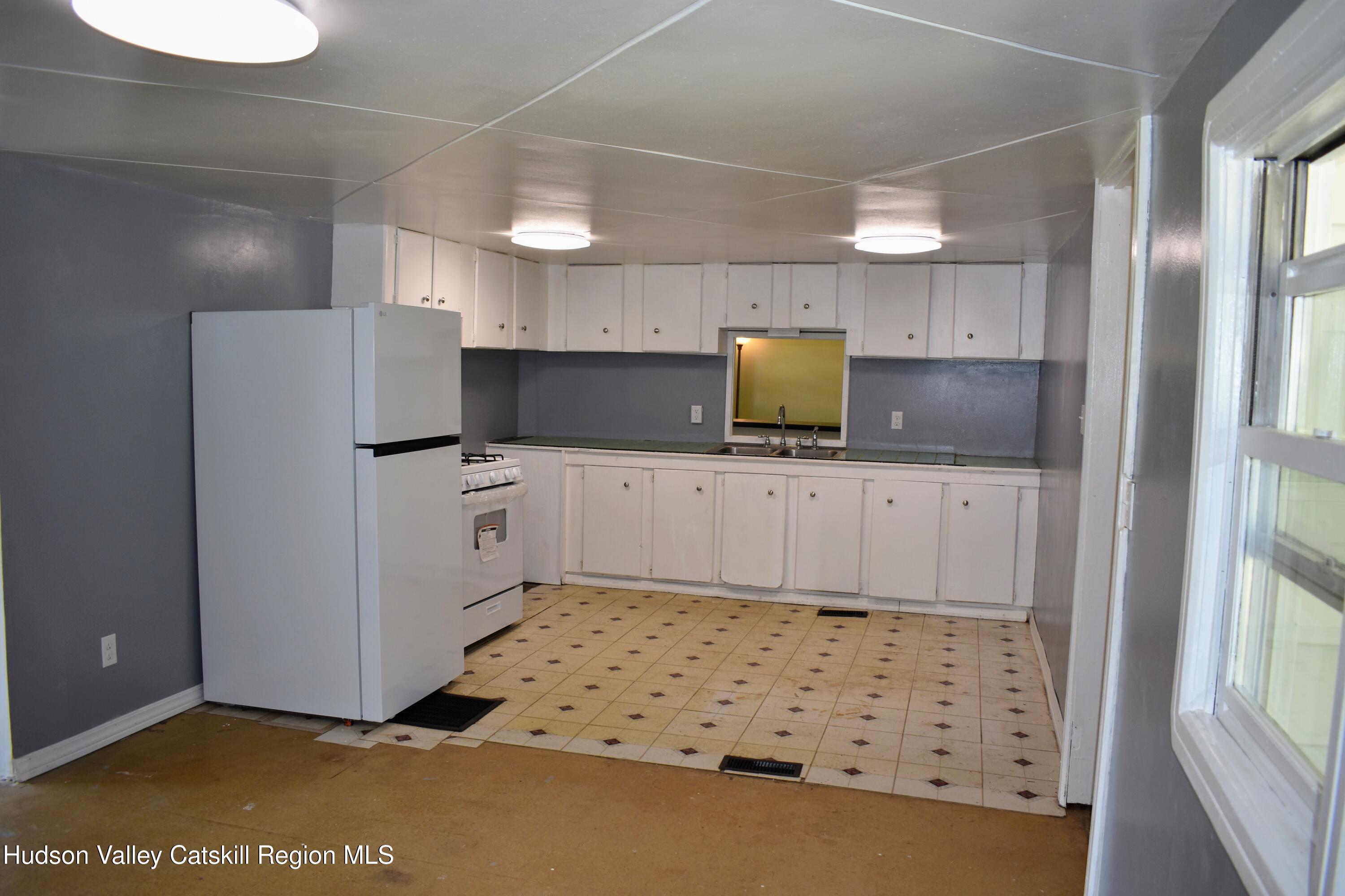 64 Dashville Road New Paltz, NY 12561 - Photo 8 of 45 a kitchen with granite countertop a sink a counter and appliances