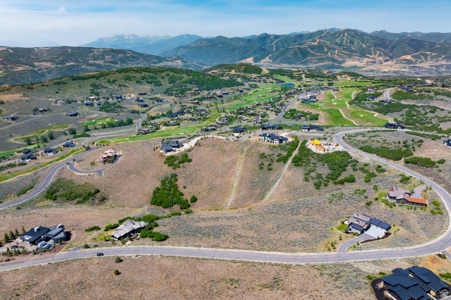 3508 Ridgeway Drive, Unit 31 Heber City, UT 84036 - Photo 13 of 13 Expansive mountainous terrain featuring scattered residential properties, paved winding roads, and distant golf course greens