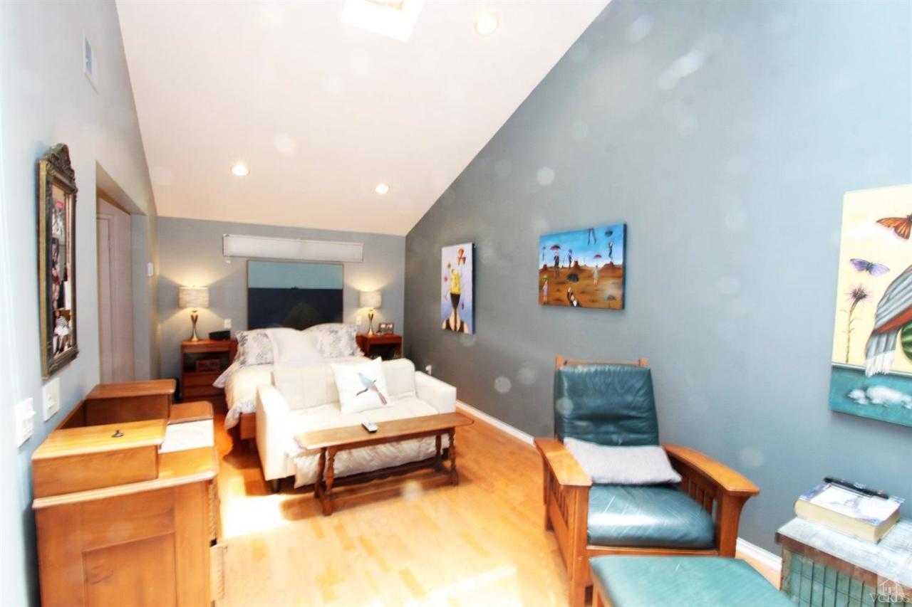 1800 Capstan Drive Oxnard, CA 93035 - Photo 9 of 15 a bedroom with a bed and wooden floor