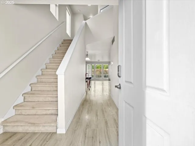 a view of entryway and hall with wooden floor