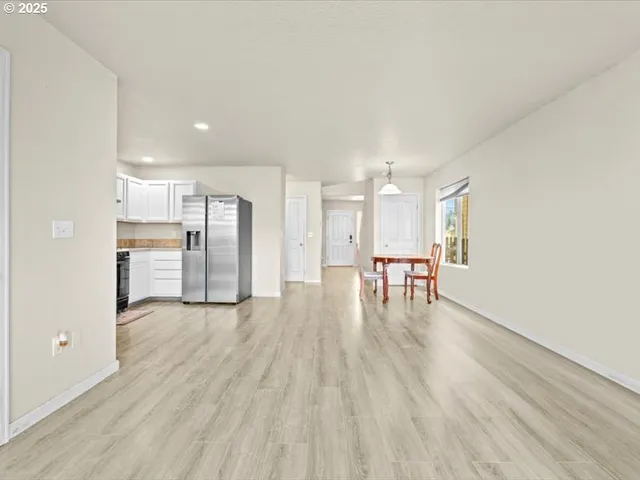 a view of a kitchen with a sink and a refrigerator
