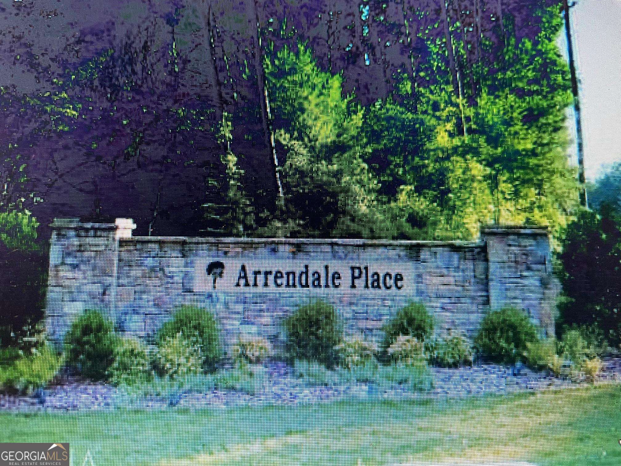 a view of sign board with yard and green space
